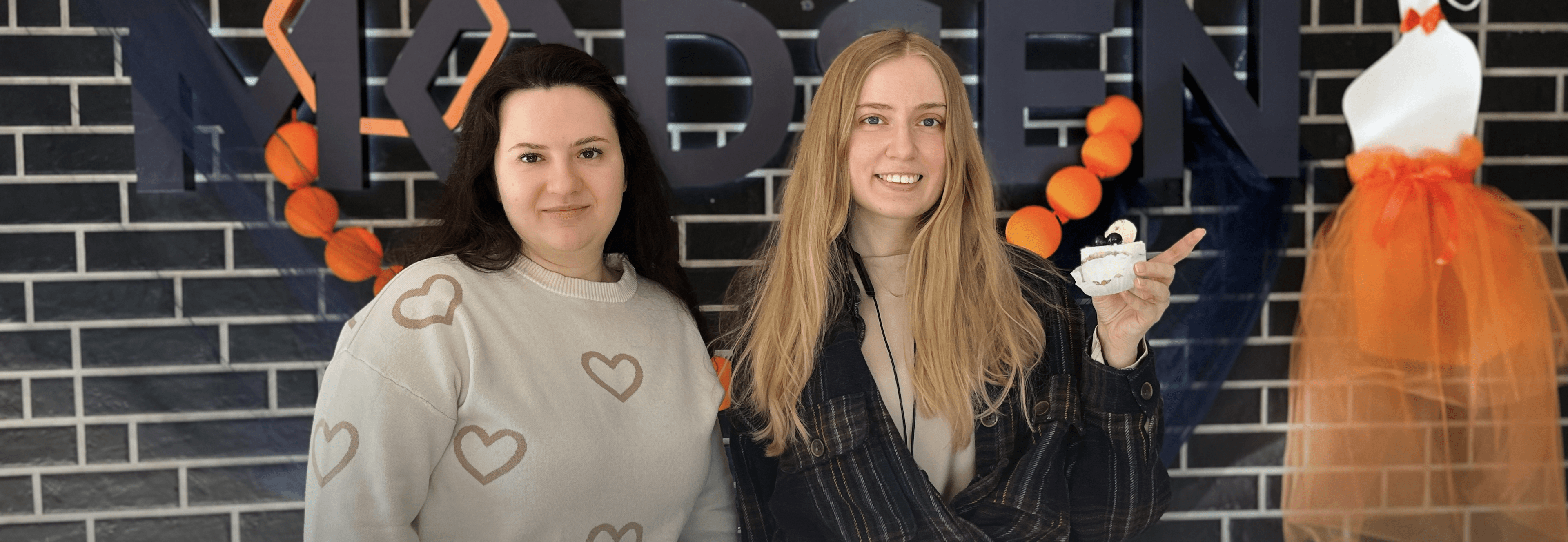 Two girls standing near Modsen International Women's Day decorations Two girls standing near Modsen International Women's Day decorations